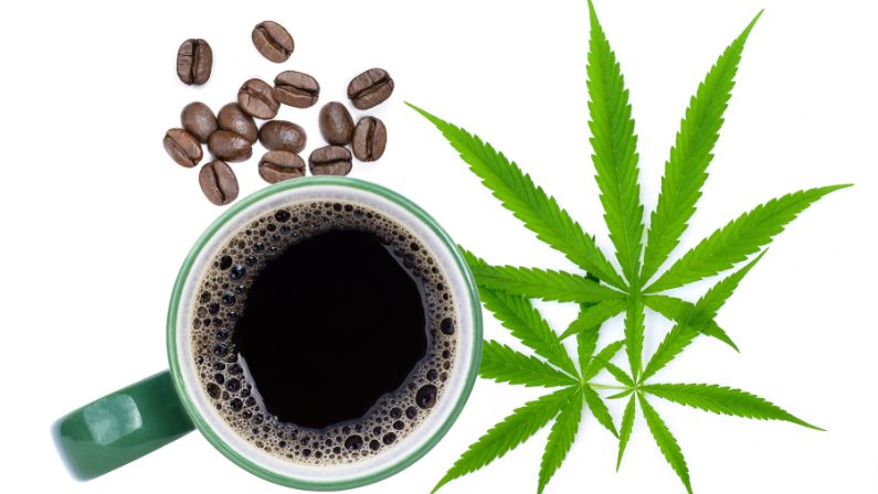 Cup of coffee with cannabis leaf and coffee beans