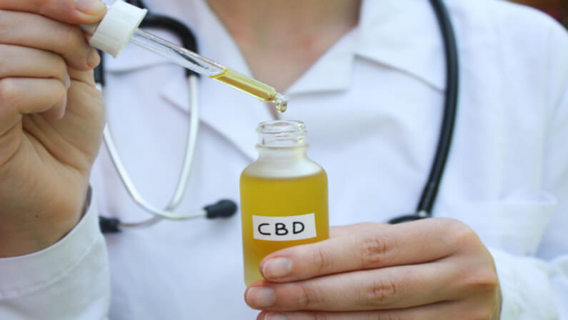 doctor holding cbd oil