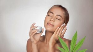 woman applying CBD facial cream made from cannabis extract for a natural skin treatment.