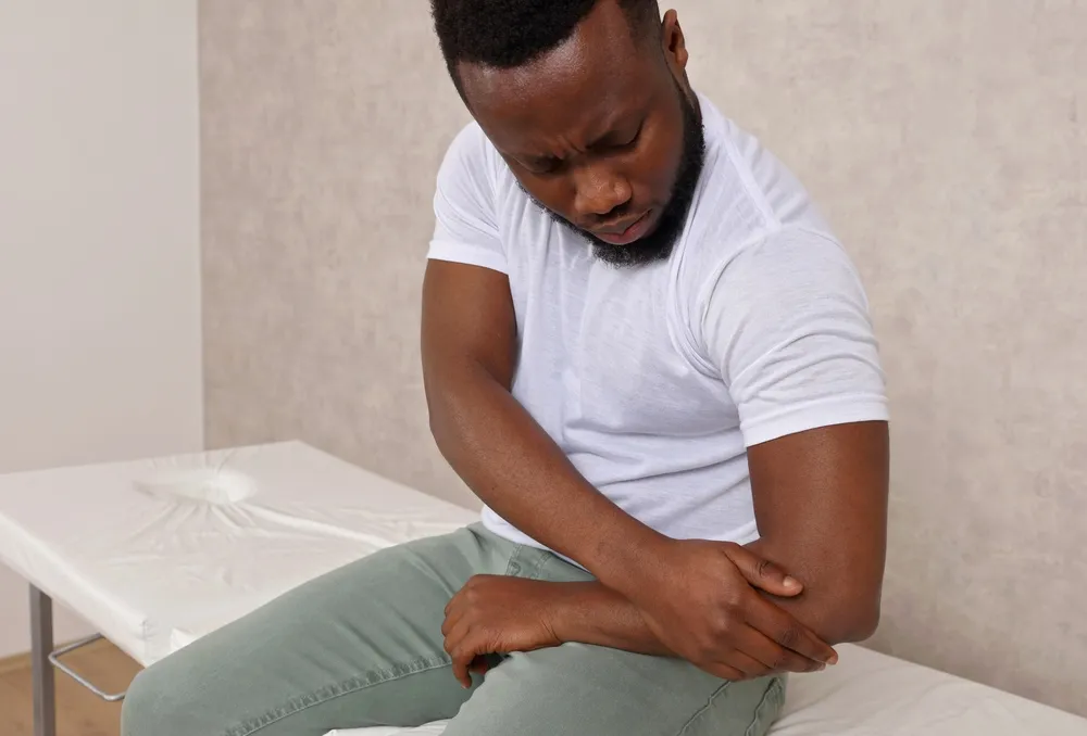 Man With Pain In Elbow. Arthritis , joint injury concept.