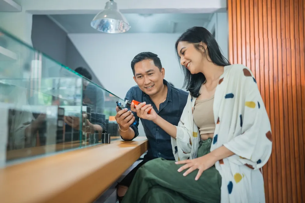 couple of vape customer comparing the vape mods at the vape store