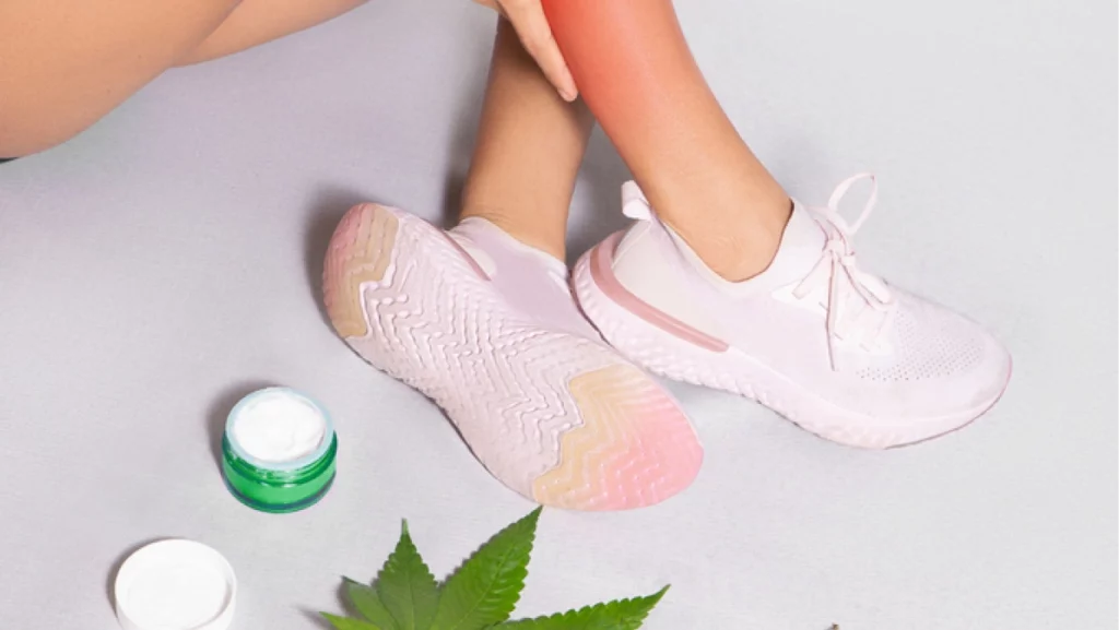 CBD ointments designed for athletes to treat muscle discomfort, woman applying cream made from cannabis extract over injured Calf leg, medical pain treatment. Isolated on gray background