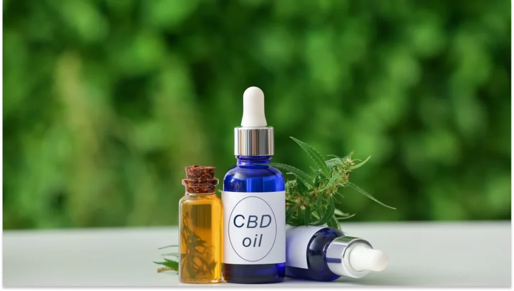 Bottles of CBD oil on table outdoors