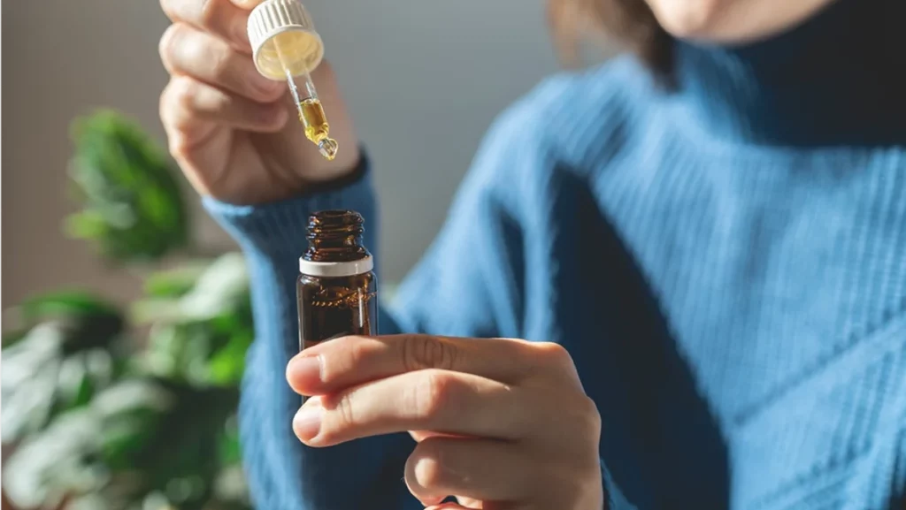 Cbd alternative therapy - Woman holding bottle of cannabis oil for anxiety treatment